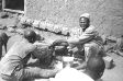 _cd1709-24-f213-87a.jpg The widower joins in the actions of the man performing the ritual (wearing hat)